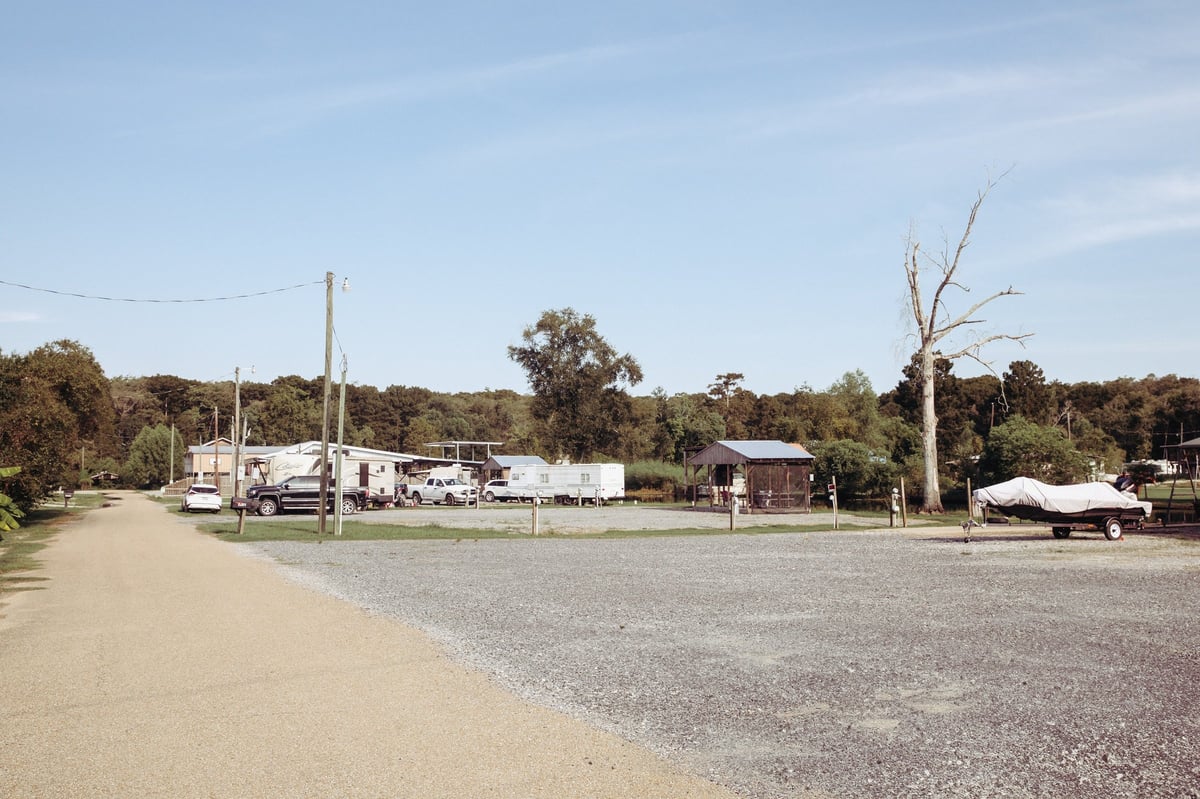 Rural property with gravel driveway and RV at Old River RV Park in Maurepas, LA